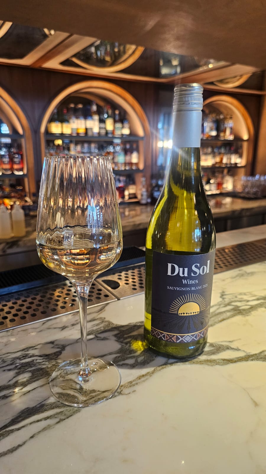 Du Sol Sauvignon Blanc and a poured glass at a wine cellar bar