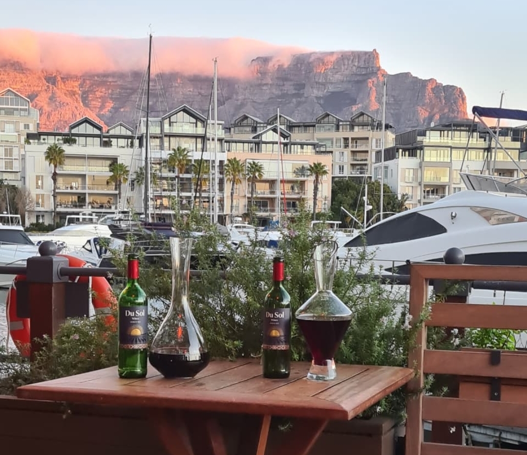 Du Sol on a marina table with Table Mountain glowing at golden hour