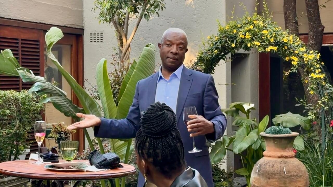 Solly hosting guests in the garden over a glass of Du Sol