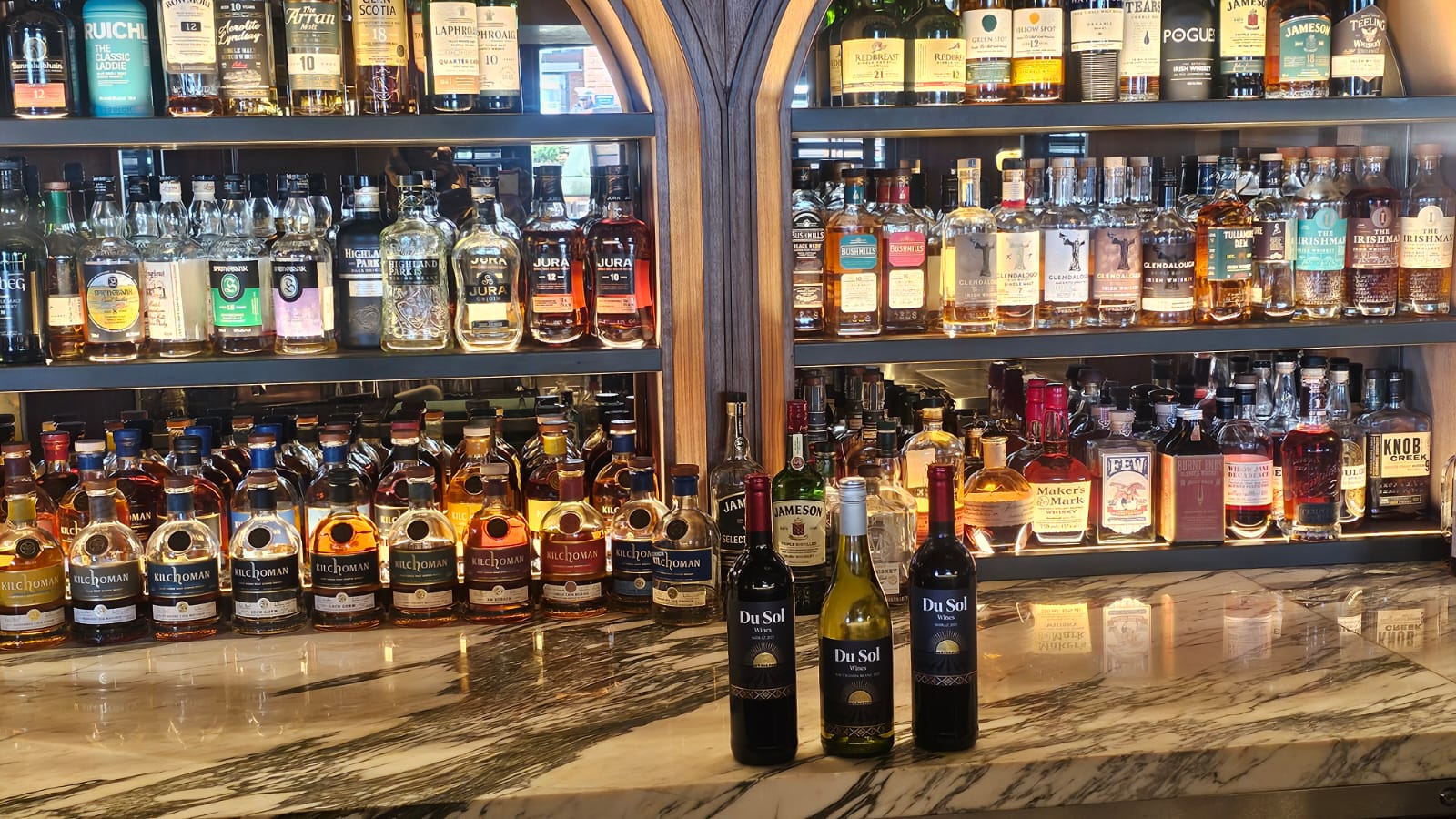 The Du Sol range lined up on a marble bar before a whisky display