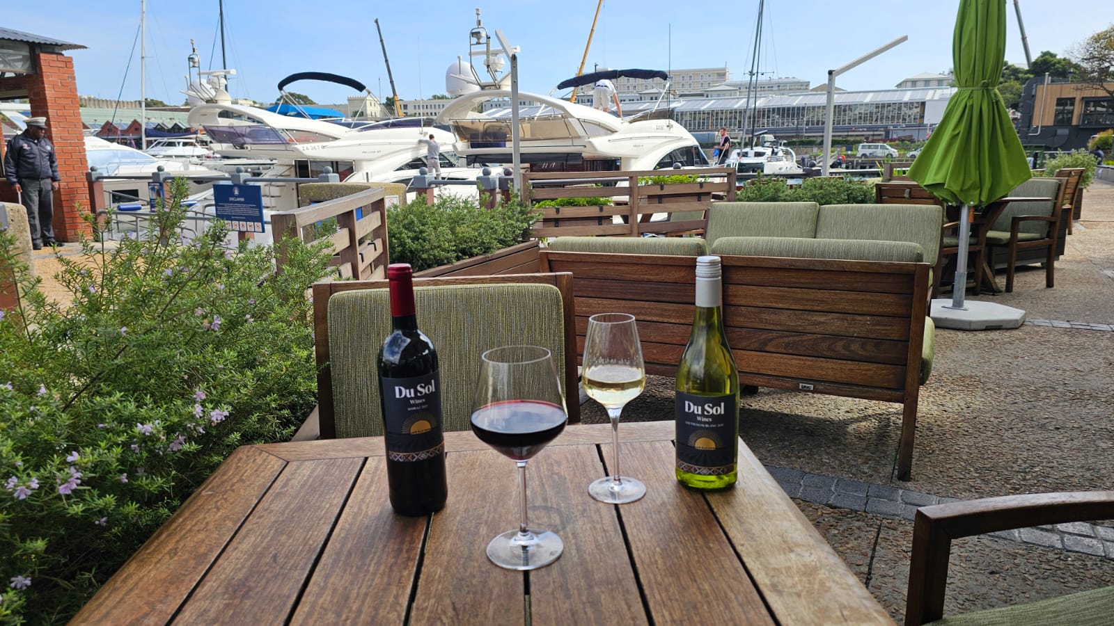 Du Sol red and white poured at a marina table with yachts in the harbour