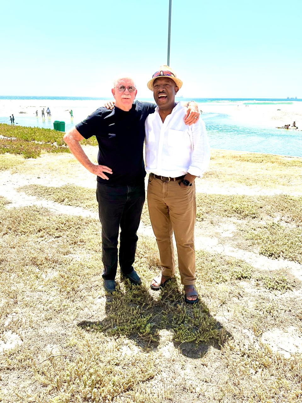 Friends arm in arm on the Cape coast