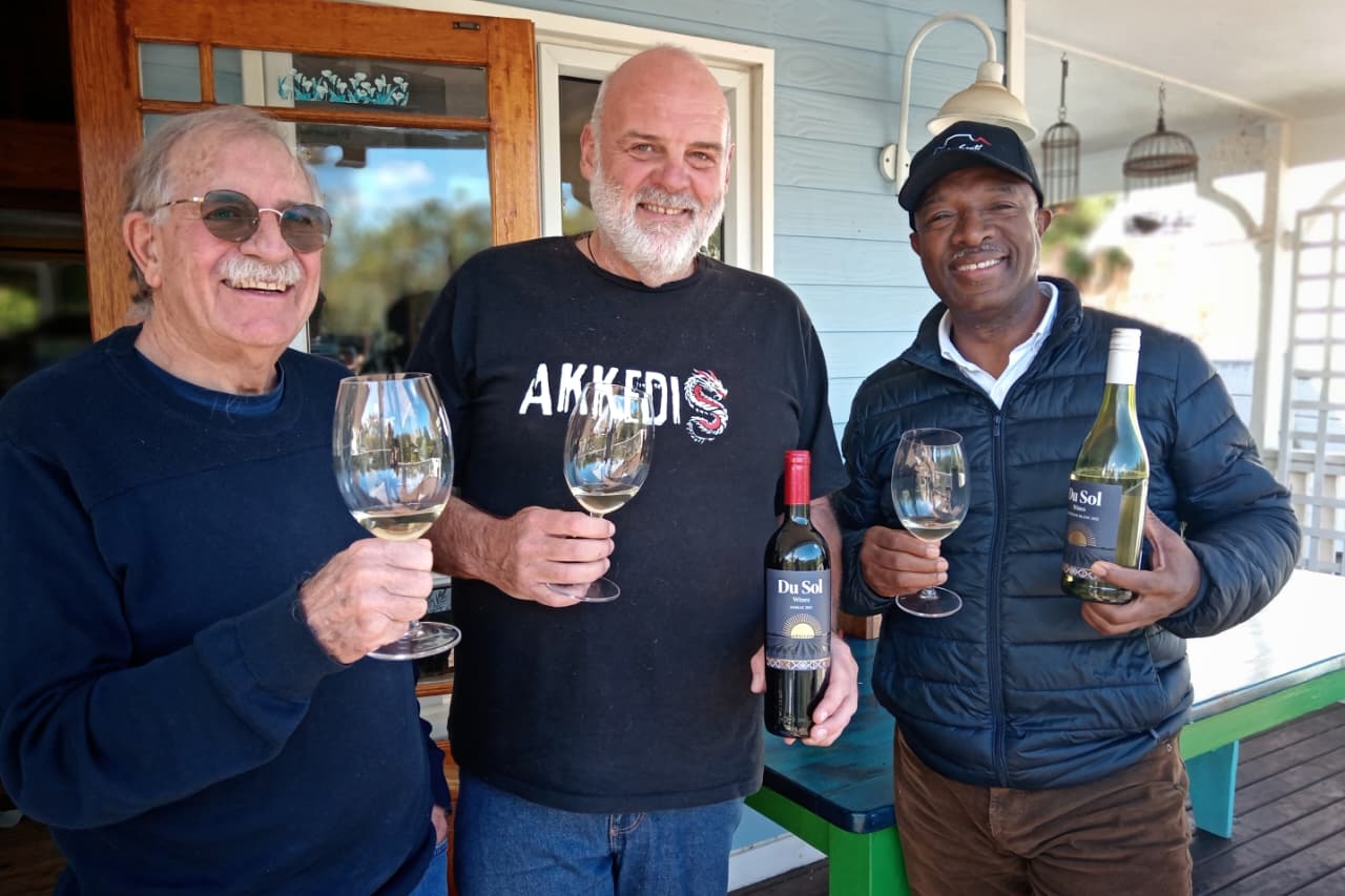 Solly with Stanley and Bertus, raising glasses